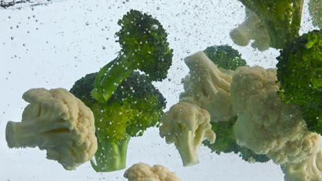 Closeup-cauliflower-broccoli-floating-in-water.-Vegetable-flowing-underwater.