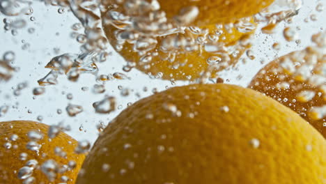 Fresh-oranges-falling-water-closeup.-Summer-sweet-fruits-splashing-liquid-in