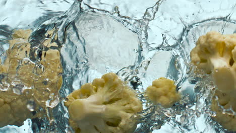 Pieces-cauliflower-dropped-water-on-white-background-close-up.-Vitamin-cabbage.