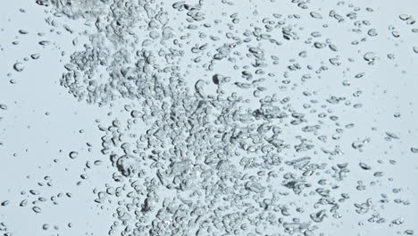 Air-bubbles-rising-water-surface-closeup.-Refreshing-sparkling-fluid-flowing