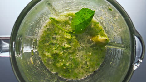 Top-view-vegetable-cocktail-preparing-in-blender-super-slow-motion-close-up.