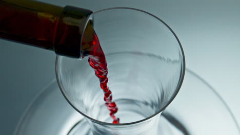 Bottle-neck-pouring-wine-decanter-closeup.-Rose-alcohol-beverage-filling-bowl