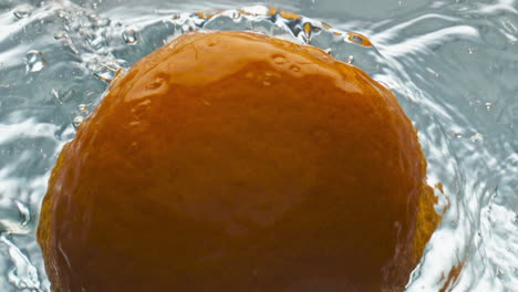 Tasty-oranges-splashing-water-closeup.-Delicious-juicy-fruits-floating-bubbling
