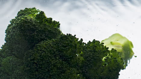 Fresh-broccoli-falling-water-closeup.-Tasty-healthy-vegetable-floating-liquid
