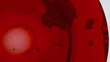 Sizzling-foam-red-liquor-surface-closeup.-Bubbled-wine-texture-moving-slowly