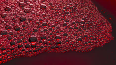 Foamy-alcoholic-drink-surface-top-view.-Wine-bubbles-bursting-slowly-closeup