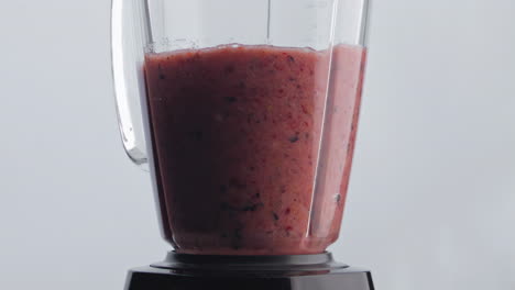 Electric-shaker-mixing-smoothie-in-super-slow-motion-close-up.-Vegan-nutrition.