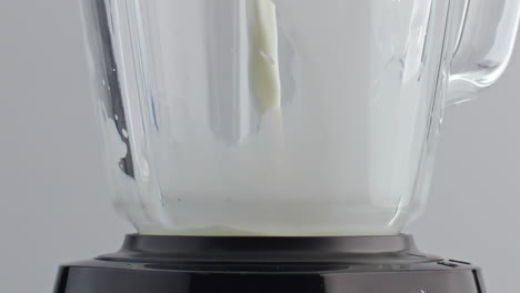 Milk-pouring-blender-bowl-in-super-slow-motion-close-up.-Preparing-cocktail.