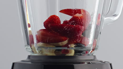 Blender-filling-fruits-berries-in-super-slow-motion-closeup.-Natural-ingredients