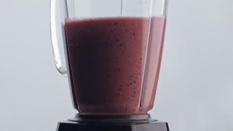 Vitamin-cocktail-blending-mixer-super-slow-motion-close-up.-Fruit-berry-blend.