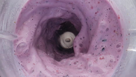 Closeup-berry-dairy-cocktail-swirling-inside-blender-in-super-slow-motion.