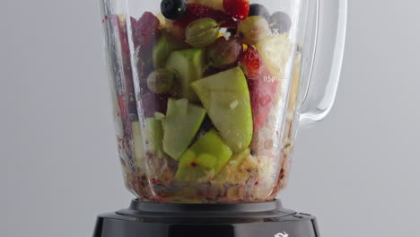 Ingredients-fruit-smoothie-blending-in-mixer-bowl-super-slow-motion-close-up.