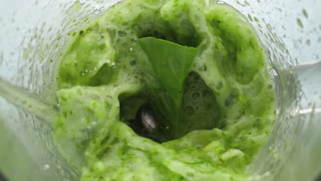 Top-view-vegan-cocktail-swirling-in-blender-close-up.-Vegetables-blending-mixer.
