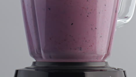 Closeup-fruit-blend-mixing-in-blender-super-slow-motion.-Natural-milkshake.