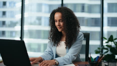 Portrait-successful-woman-specialist-working-laptop.-Girl-smiling-in-office.