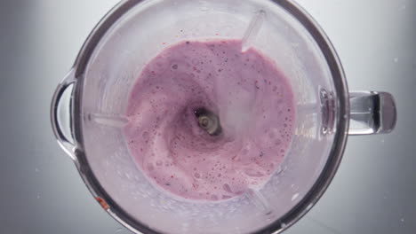 Top-view-berry-smoothie-blending-in-super-slow-motion-close-up.-Mixing-drink.