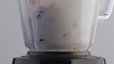Blender-mixing-milk-fruits-in-super-slow-motion-closeup.-Vitamin-milkshake.