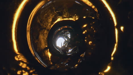 Bottled-craft-beverage-pouring-goblet-closeup.-Sparkling-cold-beer-filling-glass