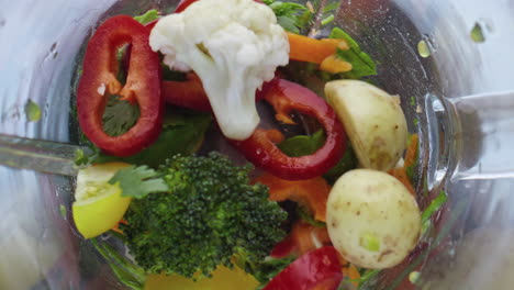 Colorful-raw-vegetables-blending-inside-blender-in-super-slow-motion-close-up.