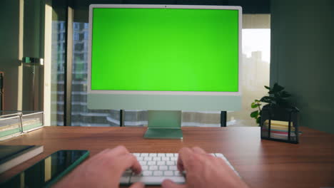 Closeup-unknown-man-typing-chromakey-computer.-Boss-arms-working-green-screen-pc
