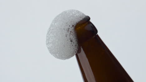 Beer-foam-flowing-bottle-neck-in-super-slow-motion-close-up.-Wheat-drink-foaming