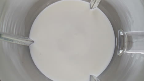 Blender-mixing-organic-milk-in-super-slow-motion-close-up.-Protein-ingredient
