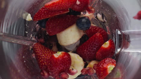 Blender-chopping-fresh-berries-in-super-slow-motion-close-up.-Juicy-ingredients