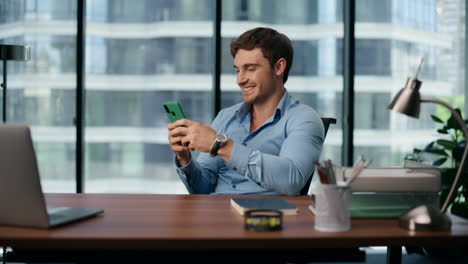 Closeup-smiling-ceo-getting-good-news-on-mobile.-Businessman-reading-message