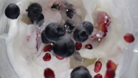 Berries-dropped-mixing-milk-in-super-slow-motion-close-up.-Vitamin-cocktail.