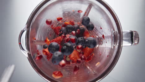 Strawberry-blueberry-falling-blender-bowl-in-super-slow-motion-close-up.