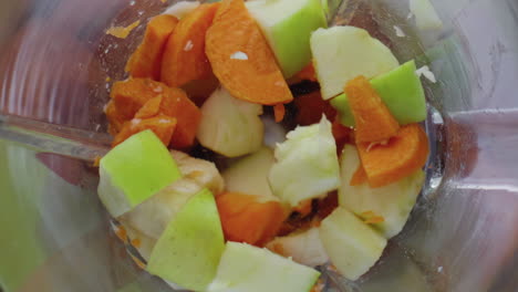 Fresh-fruits-vegetables-chopping-in-blender-super-slow-motion-close-up-top-view.