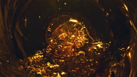 Alcohol-liquid-bubbling-glass-top-view.-Craft-beer-pouring-from-bottle-closeup