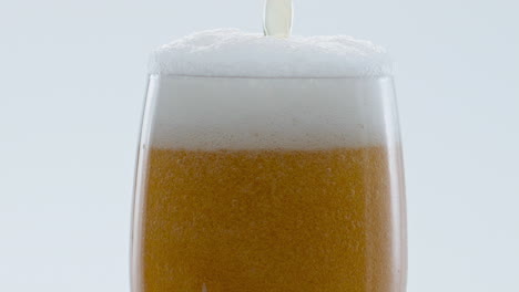 Froth-beer-pouring-bubbling-inside-glass-in-super-slow-motion-close-up.