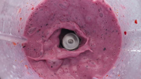 Berry-milkshake-splashing-blender-in-super-slow-motion-close-up.-Tasty-smoothie.