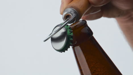 Bottle-opener-opening-beer-cup-in-super-slow-motion-close-up.-Beverage-foaming.
