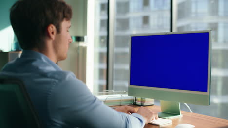 Ceo-man-looking-blue-screen-computer-closeup.-Executive-typing-mockup-device