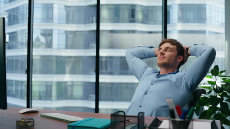 Confident-director-having-break-on-office-chair.-Businessman-relaxing-enjoying