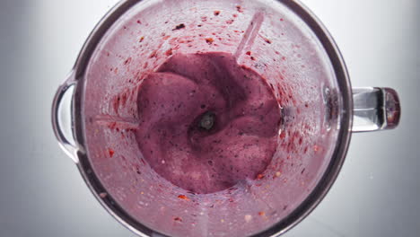 Fresh-berry-cocktail-mixing-in-blender-close-up-top-view.-Blending-smoothie.