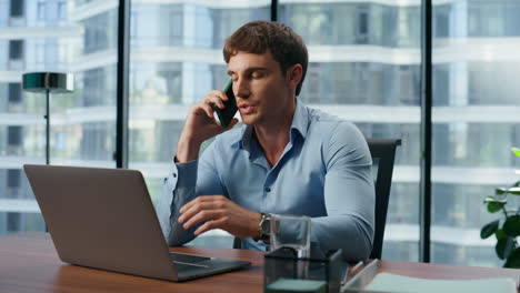 Confident-boss-talking-smartphone-office-closeup.-Manager-mobile-conversation