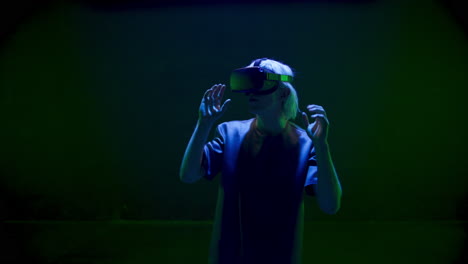 Millennial-experiencing-virtual-reality-in-neon-lights.-Impressed-metaverse-guy