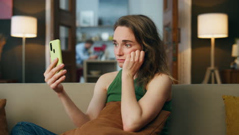 Sad-lady-talking-smartphone-home-sofa.-Depressed-woman-complaining-video-chat