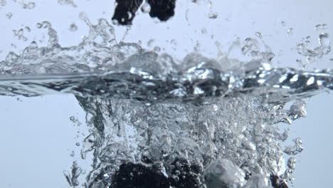 Tasty-berries-splashing-inside-aqua-closeup.-Bramble-floating-transparent-water