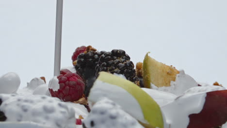 Yogurt-pouring-fruits-muesli-in-super-slow-motion-closeup.-Nutrient-healthy-food