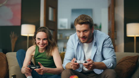 Emotional-gamers-playing-rpg-video-game.-Excited-fun-couple-holding-controllers