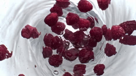 Juicy-raspberry-beverage-spinning-top-view.-Cold-drink-with-pink-berries-vortex
