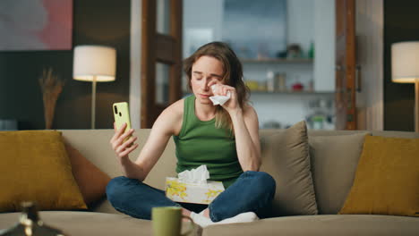 Depressed-woman-phone-calling-couch-interior.-Sad-girl-holding-napkin-suffering