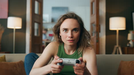 Pov-focused-player-gaming-controller-home.-Young-woman-holding-joystick-playing