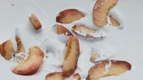 Ripe-peach-pieces-yogurt-close-up-background.-Organic-natural-fruity-milkshake.