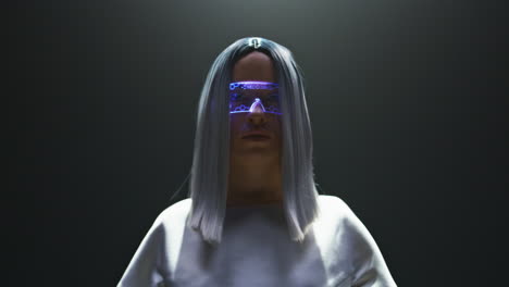 Digital-vr-glasses-girl-posing-in-light-closeup.-Beautiful-futuristic-player