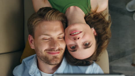 Love-couple-taking-selfie-laying-sofa-top-view.-Loving-pair-trying-face-mask-app